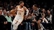 Apr 10, 2025; Brooklyn, New York, USA; Atlanta Hawks guard Trae Young (11) controls the ball against Brooklyn Nets guard Keon Johnson (45) during the second quarter at Barclays Center. Mandatory Credit: Brad Penner-Imagn Images