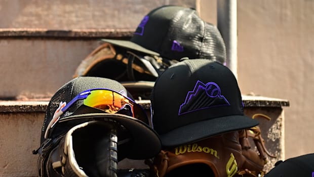 Colorado Rockies spring training hat on top of a glove in the dugout