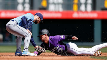 Apr 7, 2024; Denver, Colorado, USA; Colorado Rockies left fielder Nolan Jones (22) is tagged out attempting to steal second against Tampa Bay Rays second baseman Brandon Lowe (8) in the second inning at Coors Field. Mandatory Credit: Isaiah J. Downing-Imagn Images