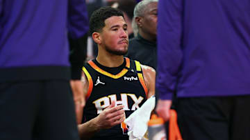 Apr 9, 2025; Phoenix, Arizona, USA; Phoenix Suns guard Devin Booker (1) reacts on the bench against the Oklahoma City Thunder during the second half at Footprint Center. Mandatory Credit: Mark J. Rebilas-Imagn Images