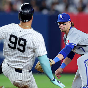 Sep 9, 2024; Bronx, New York, USA; Kansas City Royals shortstop Bobby Witt Jr. (7) tags out New York Yankees designated hitter Aaron Judge (99) at second base to complete a double play on a ball hit by Yankees catcher Austin Wells (not pictured) during the fifth inning at Yankee Stadium. Mandatory Credit: Brad Penner-Imagn Images