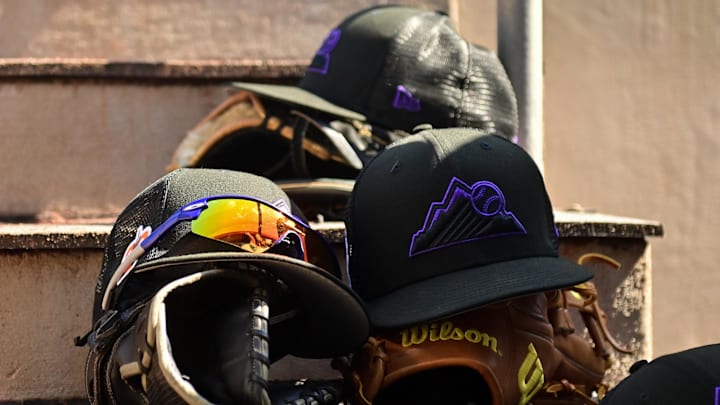 Mar 3, 2023; Scottsdale, Arizona, USA; A detail view of Colorado Rockies hats, gloves and glasses prior to the game against the San Francisco Giants during a Spring Training game at Scottsdale Stadium. Mar 3, 2023; Scottsdale, Arizona, USA; A detail view of Colorado Rockies hats, gloves and glasses prior to the game against the San Francisco Giants during a Spring Training game at Scottsdale Stadium.