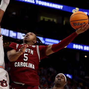 South Carolina Gamecocks guard Meechie Johnson (5) attempts a basket while being guarded by Auburn Tigers forward Johni Broome (4) during their quarterfinal game of the SEC Men's Basketball Tournament at Bridgestone Arena in Nashville, Tenn., Friday, March 15, 2024.
