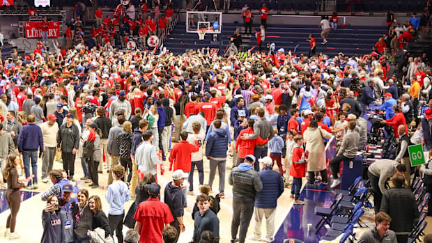 Rebels fans storm the court after winning the game against Tennessee