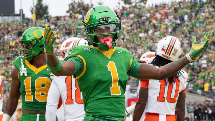 Oregon’s Dakorien Moore celebrates with Duck fans during the game against Oklahoma State.
