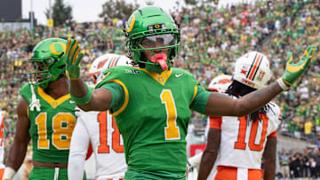 Oregon’s Dakorien Moore celebrates with Duck fans during the game against Oklahoma State.