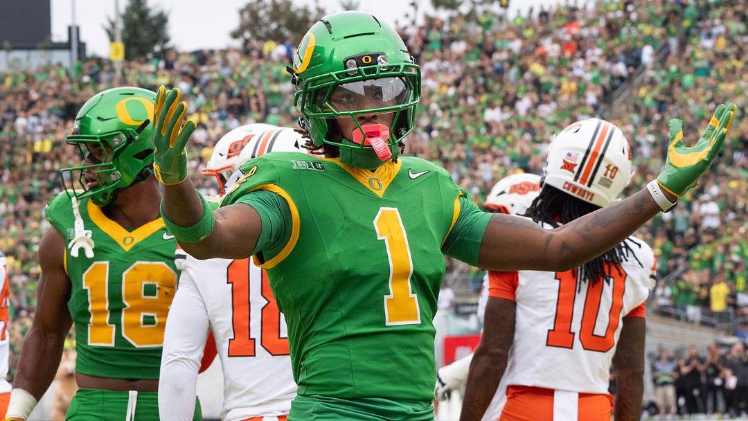 Oregon’s Dakorien Moore celebrates with Duck fans during the game against Oklahoma State.