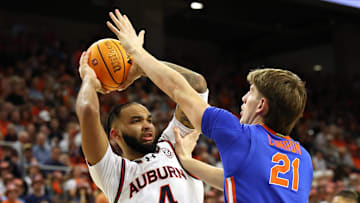 Feb 8, 2025; Auburn, Alabama, USA;  Florida Gators forward Alex Condon (21) moves in to block the shot of Auburn Tigers forward Johni Broome (4) during the second half at Neville Arena. Mandatory Credit: John Reed-Imagn Images