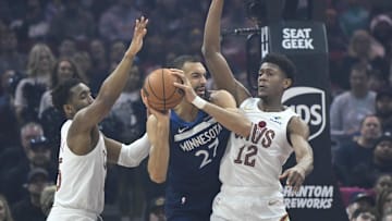 Feb 10, 2025; Cleveland, Ohio, USA; Cleveland Cavaliers guard Donovan Mitchell (45) and forward De'Andre Hunter (12) defend Minnesota Timberwolves center Rudy Gobert (27) in the first quarter at Rocket Mortgage FieldHouse. Mandatory Credit: David Richard-Imagn Images
