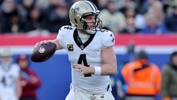 Dec 8, 2024; East Rutherford, New Jersey, USA; New Orleans Saints quarterback Derek Carr (4) drops back to pass against the New York Giants during the first quarter at MetLife Stadium. Mandatory Credit: Brad Penner-Imagn Images