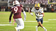 Oct 24, 2025; Blacksburg, Va.; California wide receiver Jacob de Jesus (21) runs after a catch as Virginia Tech cornerback Isaiah Brown-Murray (9) defends.