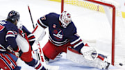 Nov 7, 2024; Winnipeg, Manitoba, CAN; Winnipeg Jets goaltender Connor Hellebuyck (37) makes a pad save in the third period against the Colorado Avalanche at Canada Life Centre. Mandatory Credit: James Carey Lauder-Imagn Images