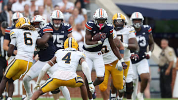 Sep 7, 2024; Auburn, Alabama, USA;  California Golden Bears defensive back Miles Williams (4) closes in on Auburn Tigers wide receiver Cam Coleman during the fourth quarter at Jordan-Hare Stadium. Mandatory Credit: John Reed-Imagn Images