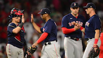 Jul 5, 2021; Anaheim, California, USA; Boston Red Sox catcher Christian Vazquez (7) third baseman Rafael Devers (11) relief pitcher Adam Ottavino (0) and first baseman Bobby Dalbec (29) celebrate the 5-4 victory against the Los Angeles Angels  at Angel Stadium. Mandatory Credit: Gary A. Vasquez-Imagn Images