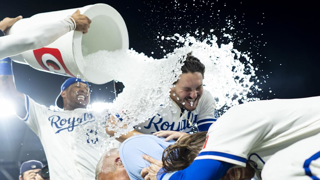 Aug 7, 2024; Kansas City, Missouri, USA; Kansas City Royals designated hitter Vinnie Pasquantino (9) and shortstop Bobby Witt Jr. (7) and broadcaster Joel Goldberg are doused by first baseman Salvador Perez (13) and left fielder MJ Melendez (1) after defeating the Boston Red Sox at Kauffman Stadium. Mandatory Credit: Jay Biggerstaff-Imagn Images