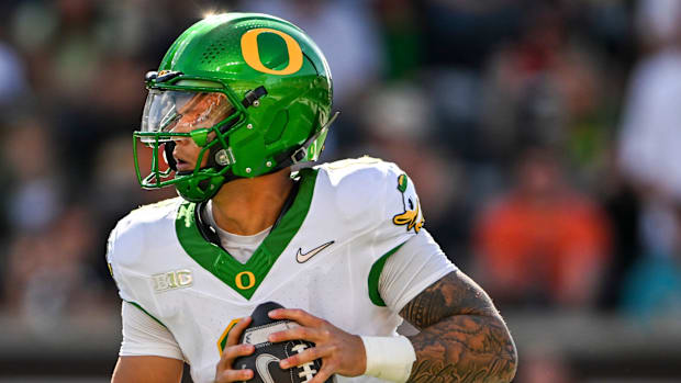Oregon Ducks quarterback Dillon Gabriel (8) looks for an opening during the second half of the annual rivalry game against th