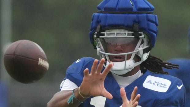 Colts receiver Adonai Mitchell (blue jersey with blue cap) makes a catch during a training camp practice. 