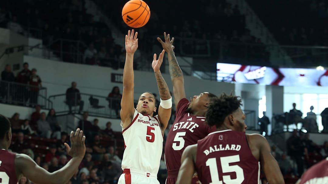 Feb 7, 2026; Starkville, Mississippi, USA; Arkansas Razorbacks guard Darius Acuff Jr. (5) shoots as Mississippi State Bulldogs guard Shawn Jones Jr. (5) defends during the first half at Humphrey Coliseum. Mandatory Credit: Petre Thomas-Imagn Images