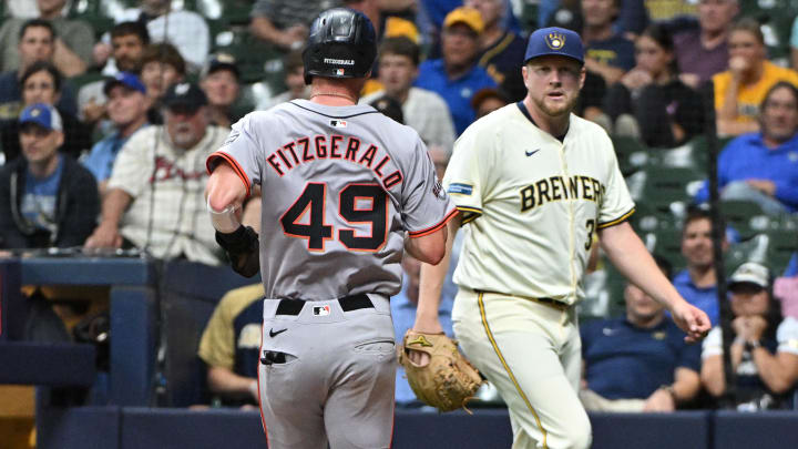 Aug 28, 2024; Milwaukee, Wisconsin, USA; San Francisco Giants shortstop Tyler Fitzgerald (49) scores a run against Milwaukee Brewers relief pitcher Jared Koenig (35) in the eighth inning at American Family Field.