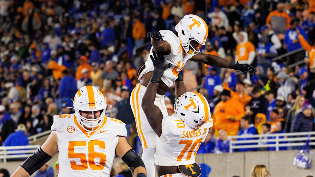 Oct 25, 2025; Lexington, Kentucky, USA; Tennessee Volunteers offensive lineman David Sanders Jr. (70) celebrates with wide receiver Mike Matthews (4) after Matthews scores a touchdown during the third quarter against the Kentucky Wildcats at Kroger Field. Mandatory Credit: Jordan Prather-Imagn Images