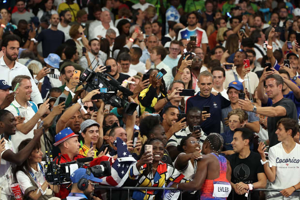 After winning the 100 in a photo finish, Lyles embraced his mom and family members in the stands.