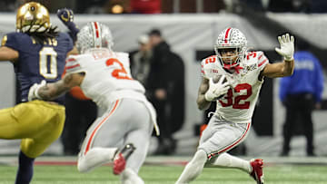 Ohio State Buckeyes running back TreVeyon Henderson (32) runs during the College Football Playoff National Championship against the Notre Dame Fighting Irish at Mercedes-Benz Stadium in Atlanta on Jan. 22, 2025.