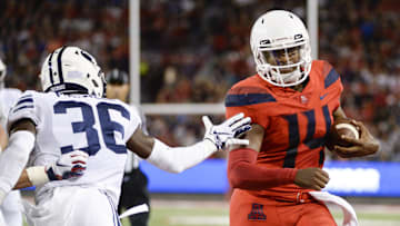 Sep 1, 2018; Tucson, AZ, USA; Arizona Wildcats quarterback Khalil Tate (14) runs the ball against Brigham Young Cougars defensive back D'Angelo Mandell (36) during the first half at Arizona Stadium. Mandatory Credit: Casey Sapio-Imagn Images