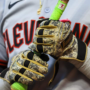 May 17, 2025; Cincinnati, Ohio, USA; A detail view of the gloves of Cleveland Guardians outfielder Angel Martinez (1) as he prepares on deck in the seventh inning against the Cincinnati Reds at Great American Ball Park. Mandatory Credit: Katie Stratman-Imagn Images