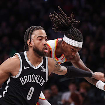 Mar 16, 2025; Brooklyn, New York, USA; Brooklyn Nets forward Trendon Watford (9) drives to the basket against Atlanta Hawks guard Terance Mann (14) during the second half at Barclays Center. Mandatory Credit: Vincent Carchietta-Imagn Images