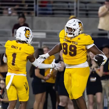 Sep 7, 2024; Tempe, Arizona, USA; Arizona State Sun Devils defensive lineman C.J. Fite (99) celebrates with defensive back Keith Abney II (1) after recovering a fumble for a touchdown against the Mississippi State Bulldogs in the first half at Mountain America Stadium. Mandatory Credit: Mark J. Rebilas-Imagn Images