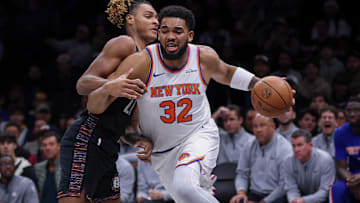Nov 24, 2025; Brooklyn, New York, USA; New York Knicks center Karl-Anthony Towns (32) drives to the basket against Brooklyn Nets forward Noah Clowney (21) during the first quarter at Barclays Center. Mandatory Credit: Vincent Carchietta-Imagn Images