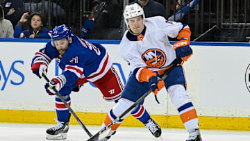 Apr 13, 2024; New York, New York, USA;  New York Islanders center Mathew Barzal (13) controls the puck defended by New York Rangers center Barclay Goodrow (21) during the third period at Madison Square Garden.