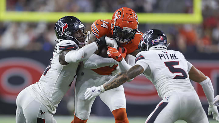 Sep 15, 2024; Houston, Texas, USA; Houston Texans defensive end Will Anderson Jr. (51) and safety Jalen Pitre (5) attempt to tackle Chicago Bears tight end Gerald Everett (14) during the second quarter at NRG Stadium. Mandatory Credit: Troy Taormina-Imagn Images