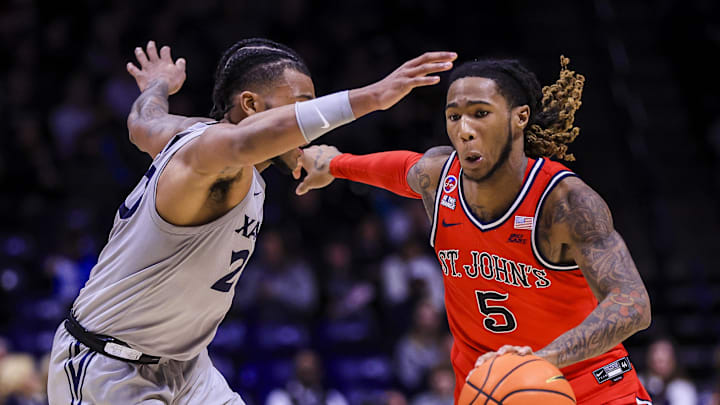 Jan 7, 2025; Cincinnati, Ohio, USA; St. John's basketball guard Deivon Smith (5) dribbles against Xavier Musketeers guard Dayvion McKnight (20) in the second half at Cintas Center. 