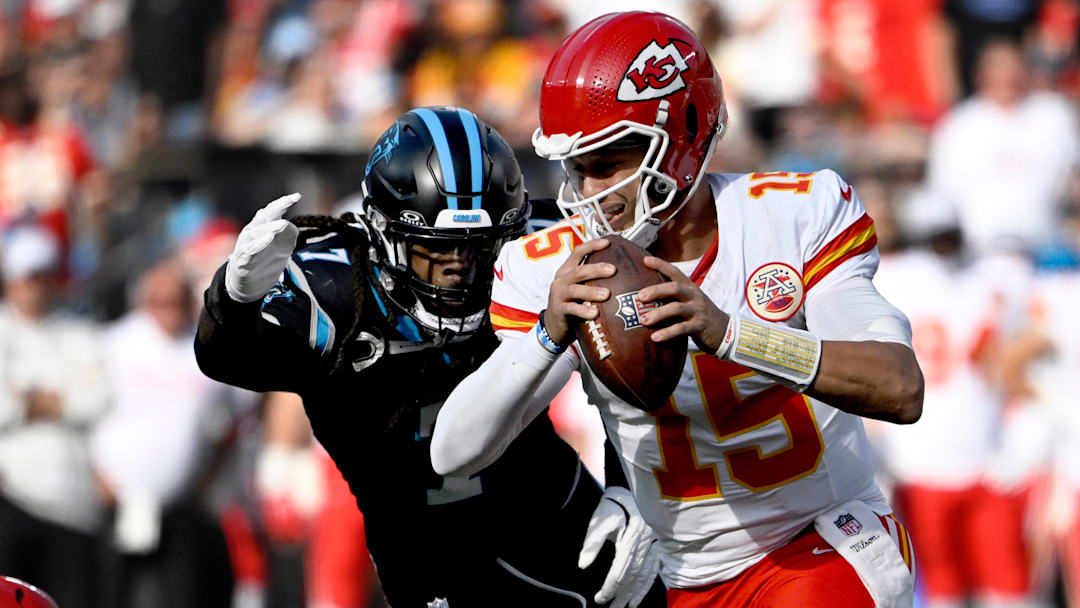Nov 24, 2024; Charlotte, North Carolina, USA; Kansas City Chiefs quarterback Patrick Mahomes (15) is sacked by Carolina Panthers linebacker Jadeveon Clowney (7) in the second quarter at Bank of America Stadium. Mandatory Credit: Bob Donnan-Imagn Images