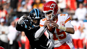 Nov 24, 2024; Charlotte, North Carolina, USA; Kansas City Chiefs quarterback Patrick Mahomes (15) is sacked by Carolina Panthers linebacker Jadeveon Clowney (7) in the second quarter at Bank of America Stadium. Mandatory Credit: Bob Donnan-Imagn Images