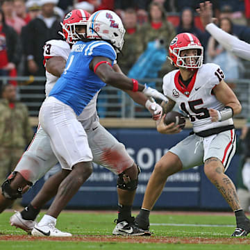 Georgia Bulldogs quarterback Carson Beck (15) drops back to pass as Mississippi Rebels defensive Jared Ivey (15) rushes during the first half at Vaught-Hemingway Stadium. Georgia has to win this week against Tennessee to keep its College Football Playoff hopes alive.