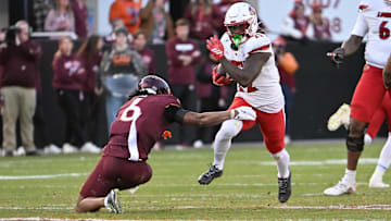 Nov 1, 2025; Blacksburg, Va.; Virginia Tech safety Jordan Bass (6) attempts to tackle Louisville running back Keyjuan Brown (22).
