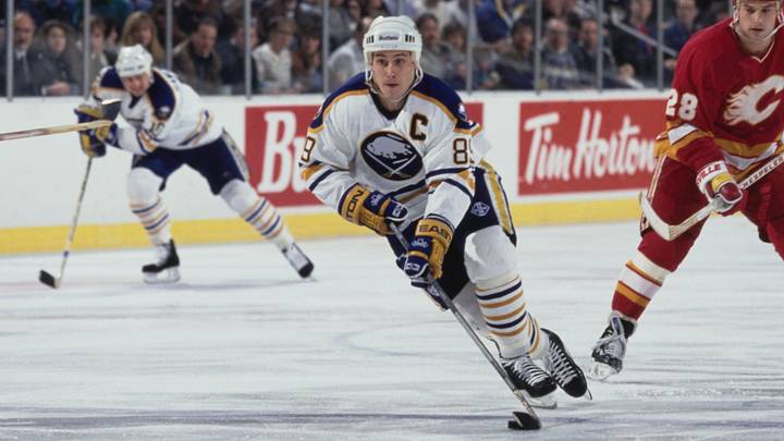 Alexander Mogilny #89 from Russia and Captain, Right Wing for the Buffalo Sabres in motion on the ice skating past #28 Paul Ranheim of the Calgary Flames during their NHL Eastern Conference Northeast Division game on 10th December 1993 at the Buffalo Memorial Auditorium in Buffalo, New York, United States. The Buffalo Sabres won the game 6 - 2. (Photo by Rick Stewart/Allsport/Getty Images)
