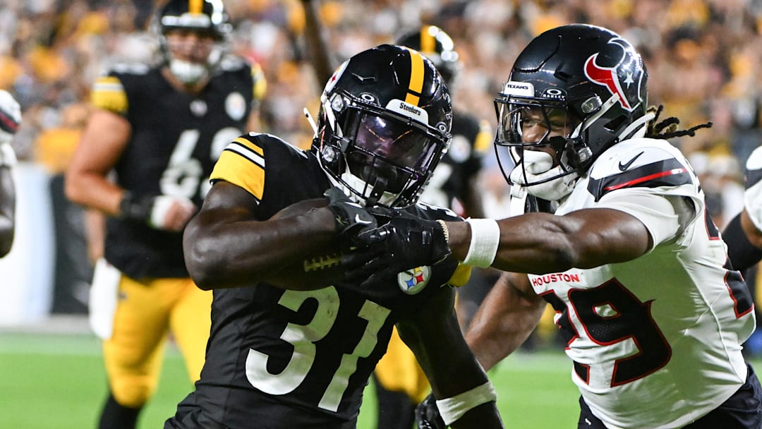 Aug 9, 2024; Pittsburgh, Pennsylvania, USA; Pittsburgh Steelers running back Daijun Edwards (31) fights off Houston Texans safety M.J. Stewart (29) during the third quarter at Acrisure Stadium. Mandatory Credit: Barry Reeger-Imagn Images