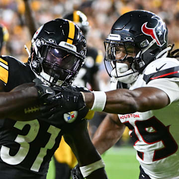 Aug 9, 2024; Pittsburgh, Pennsylvania, USA; Pittsburgh Steelers running back Daijun Edwards (31) fights off Houston Texans safety M.J. Stewart (29) during the third quarter at Acrisure Stadium. Mandatory Credit: Barry Reeger-Imagn Images