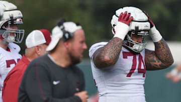 The Crimson Tide football team continued practice Thursday, Aug. 1, 2024, as they prepare for the season opener and the first game under new head coach Kalen DeBoer. Alabama offensive lineman Kadyn Proctor (74) secures his helmet during practice.