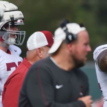 The Crimson Tide football team continued practice Thursday, Aug. 1, 2024, as they prepare for the season opener and the first game under new head coach Kalen DeBoer. Alabama offensive lineman Kadyn Proctor (74) secures his helmet during practice.