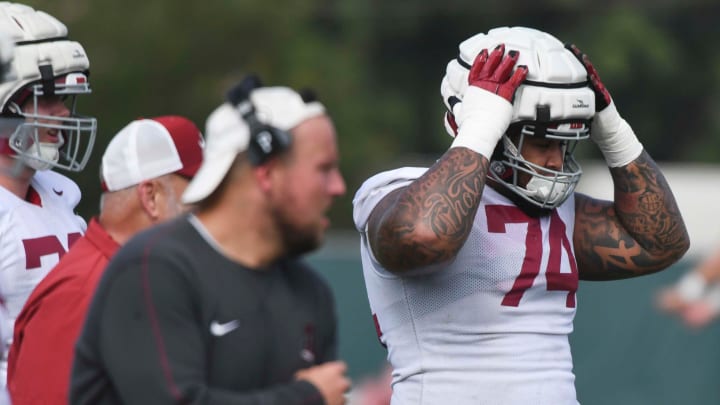 The Crimson Tide football team continued practice Thursday, Aug. 1, 2024, as they prepare for the season opener and the first game under new head coach Kalen DeBoer. Alabama offensive lineman Kadyn Proctor (74) secures his helmet during practice.