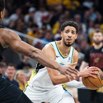 May 11, 2025; Indianapolis, Indiana, USA; Indiana Pacers guard Tyrese Haliburton (0) holds the ball while Cleveland Cavaliers forward De'Andre Hunter (12) defends during game four of the second round for the 2025 NBA Playoffs at Gainbridge Fieldhouse. Mandatory Credit: Trevor Ruszkowski-Imagn Images