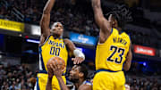 Feb 2, 2024; Indianapolis, Indiana, USA; Sacramento Kings forward Harrison Barnes (40) shoots the ball while Indiana Pacers guard Bennedict Mathurin (00) and forward Aaron Nesmith (23) defend in the second half at Gainbridge Fieldhouse. Mandatory Credit: Trevor Ruszkowski-Imagn Images