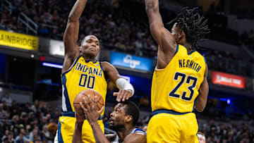 Feb 2, 2024; Indianapolis, Indiana, USA; Sacramento Kings forward Harrison Barnes (40) shoots the ball while Indiana Pacers guard Bennedict Mathurin (00) and forward Aaron Nesmith (23) defend in the second half at Gainbridge Fieldhouse. Mandatory Credit: Trevor Ruszkowski-Imagn Images