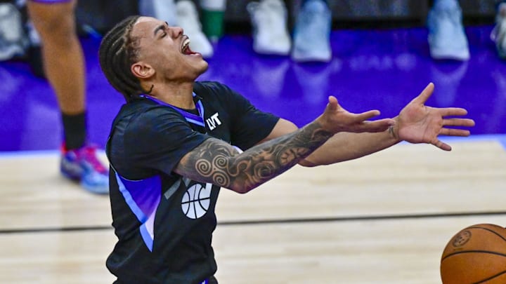 Dec 23, 2025; Salt Lake City, Utah, USA; Utah Jazz guard Keyonte George (3) reacts to being fouled by Memphis Grizzlies guard Kentavious Caldwell-Pope (3) during the second half at Delta Center. Mandatory Credit: Peter Creveling-Imagn Images