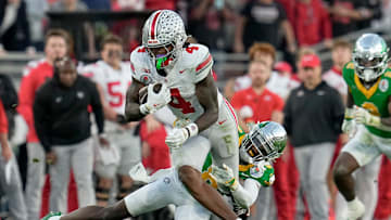 Ohio State Buckeyes wide receiver Jeremiah Smith (4) runs past Oregon Ducks defensive back Dontae Manning (8) during the College Football Playoff quarterfinal at the Rose Bowl in Pasadena, Calif. on Jan. 1, 2025. Ohio State won 41-21.