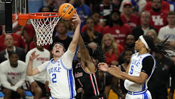 Apr 5, 2025; San Antonio, TX, USA; Duke Blue Devils forward Cooper Flagg (2) grabs a rebound over Houston Cougars forward Joseph Tugler (11) during the second half in the semifinals of the men's Final Four of the 2025 NCAA Tournament at Alamodome. Mandatory Credit: Scott Wachter-Imagn Images
